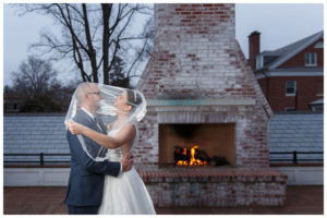 Bride and Groom portrait on the upper deck in front of the fireplace at the Inn on Boltwood