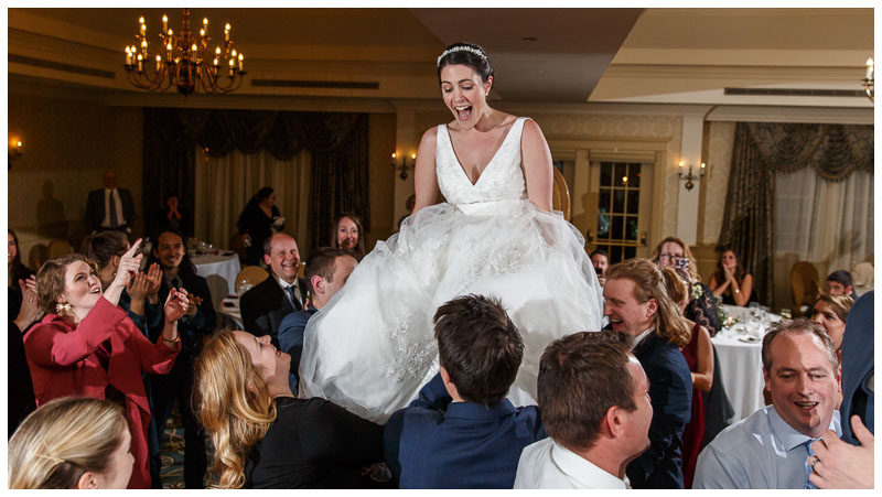 Bride raised up in the air on a chair during huppa dance