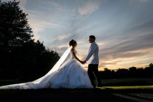 Bride and Groom sunset photo with dramatic sky in background