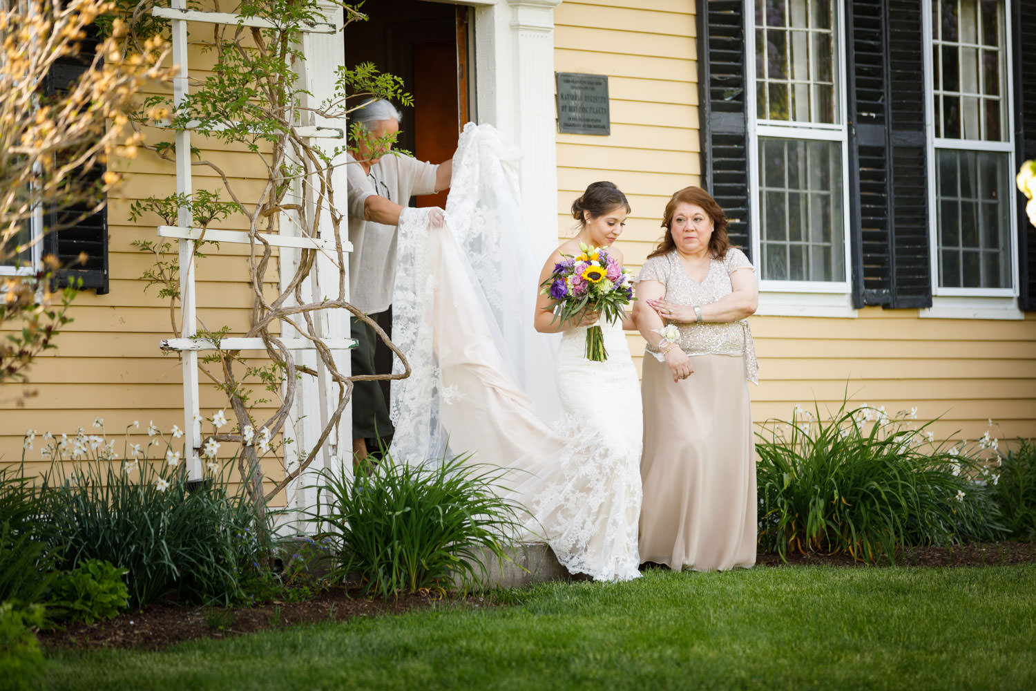 Bride and mother walking out of the Salem Cross Inn to the outdoor ceremony