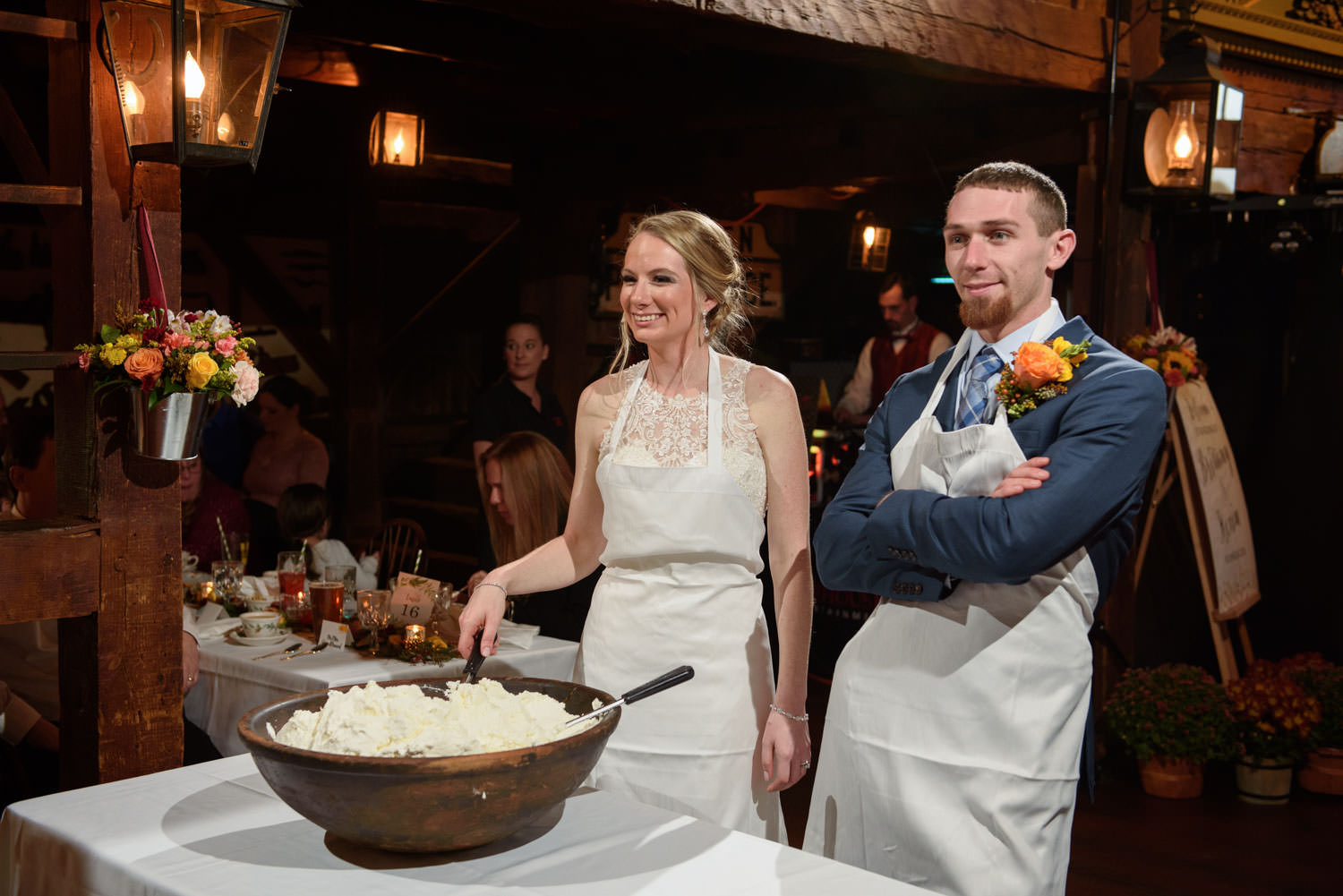 Bride and Groom Dishing out Whipped cream from huge bowl for the apple pie