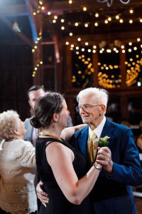 Grandpa of the bride dancing with guest at receptions