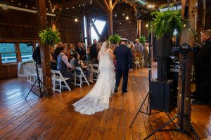 Bride during recessional with father during indoor ceremony