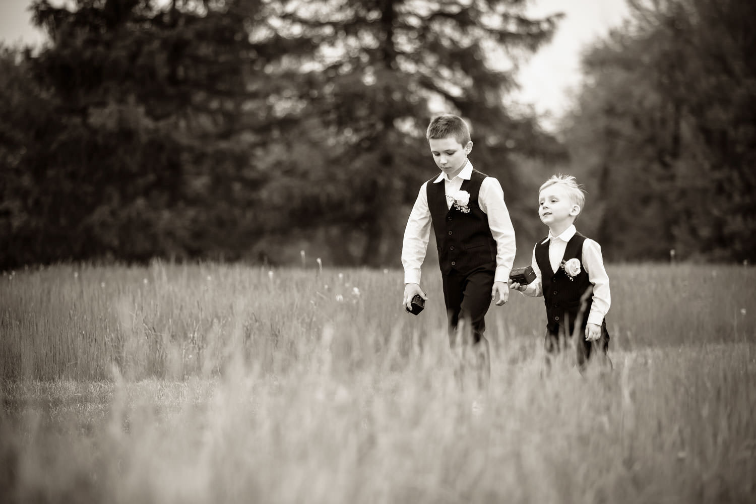Black and White photo of ring bearers walking down the aisle
