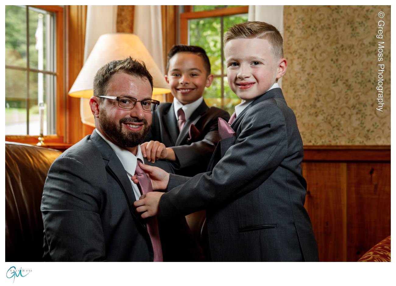 Groom getting ready for wedding with sons