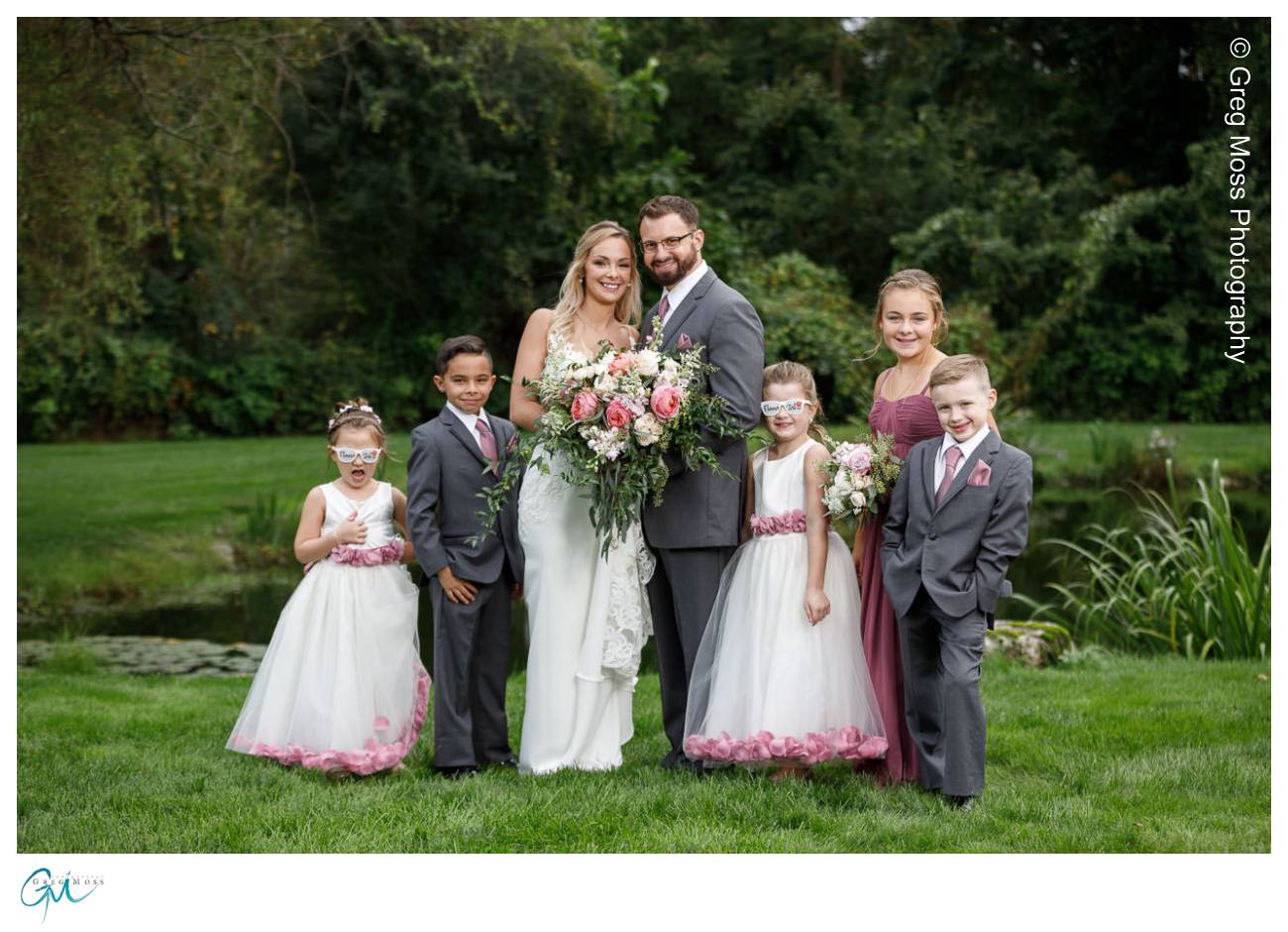 Family portrait on wedding day with bride and groom and their 5 kids