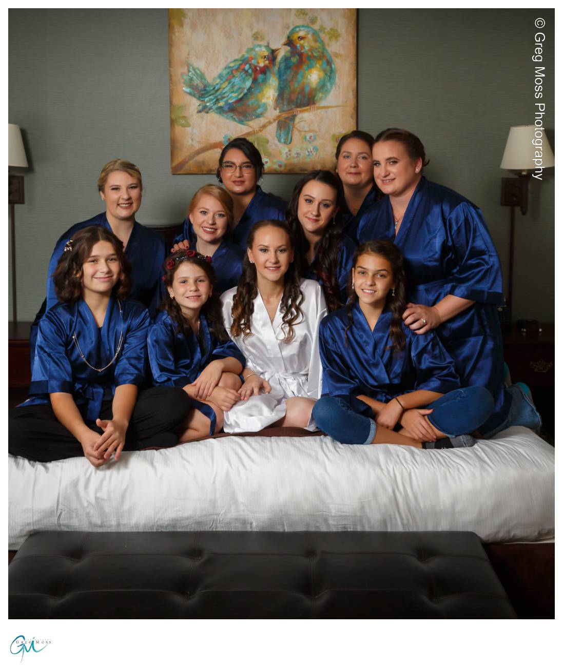 Bride and Bridesmaids in robes on bed
