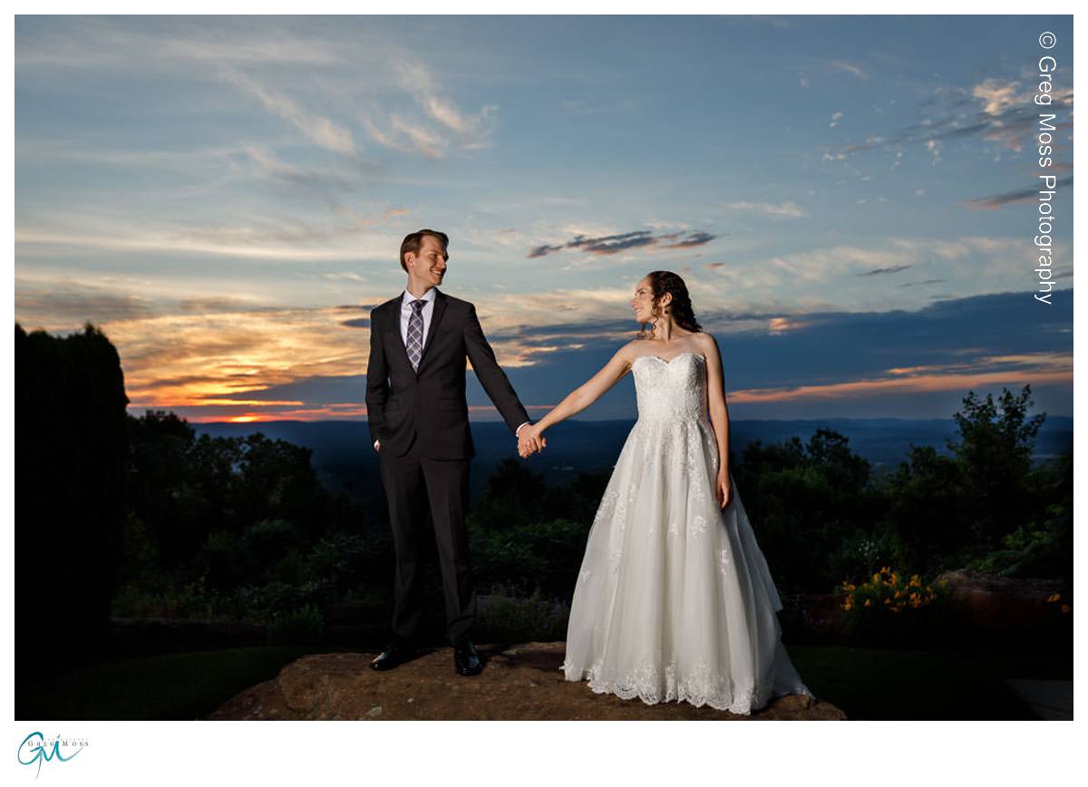 Bride and Groom holding hands at sunset