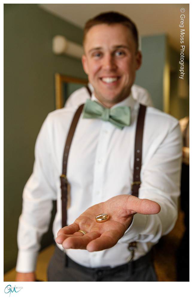 Best man holding ring during getting ready portion of the day
