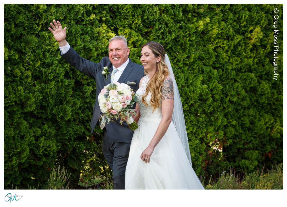 Father walking bride down the aisle during outdoor ceremony