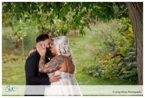 Bride and Groom kissing under a tree