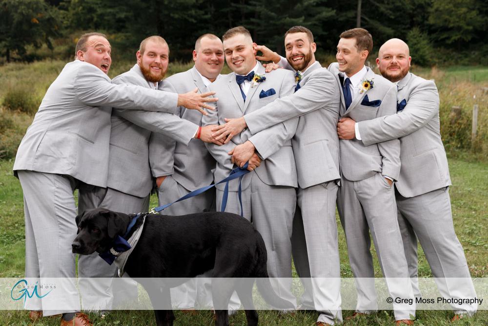 Groom and groomsmen with dog