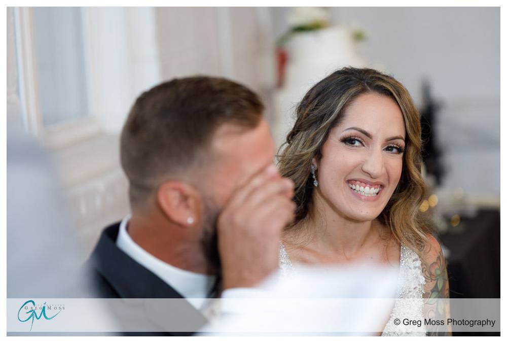 Bride laughing during Best Man's speech during reception