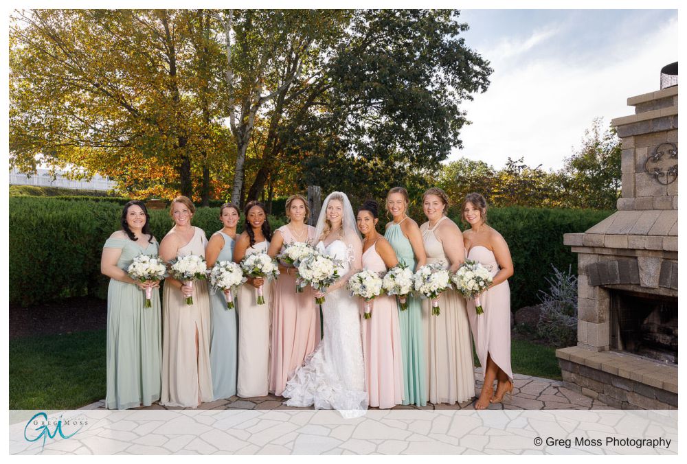 Bridal party wearing pastel color dresses outside in the fall