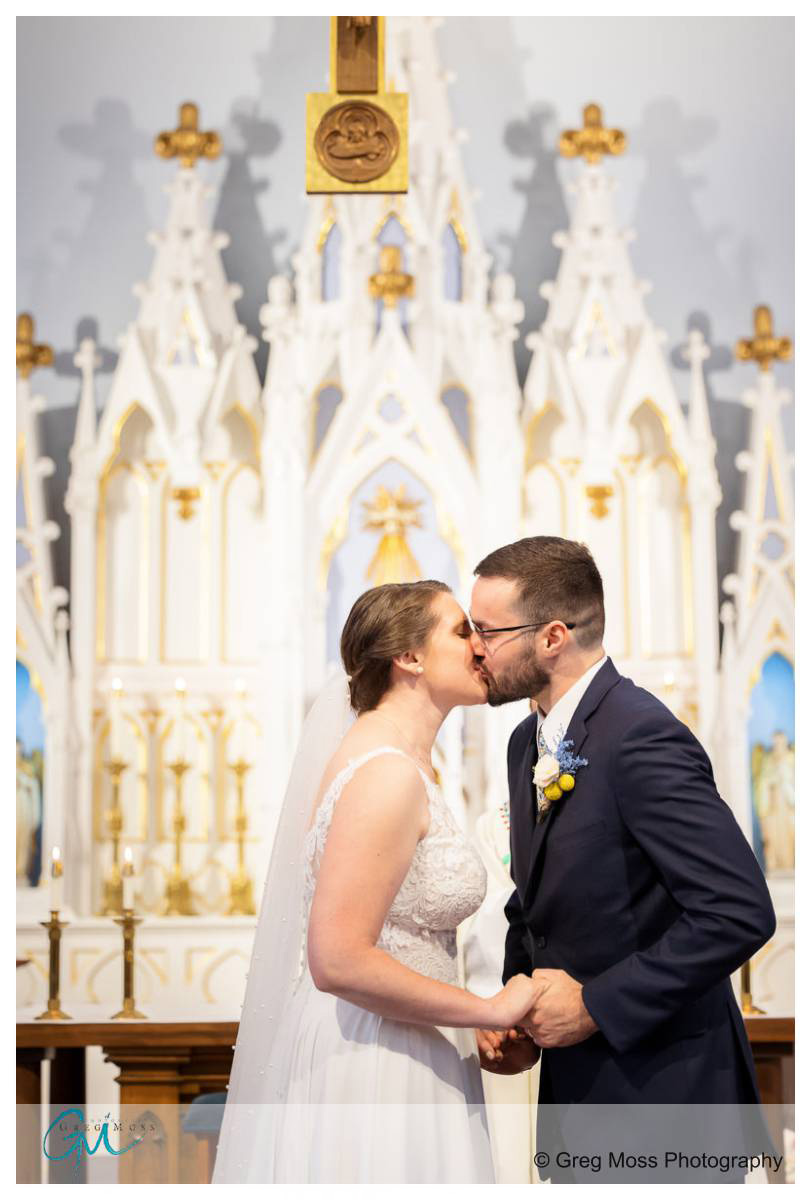 Wedding couple first kiss at Our Lady of the Valley Parish in Easthampton Ma