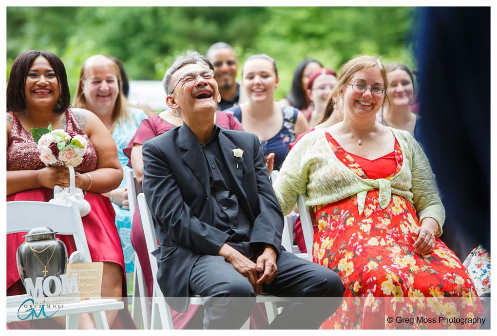 Father of the bride laughing during ceremony