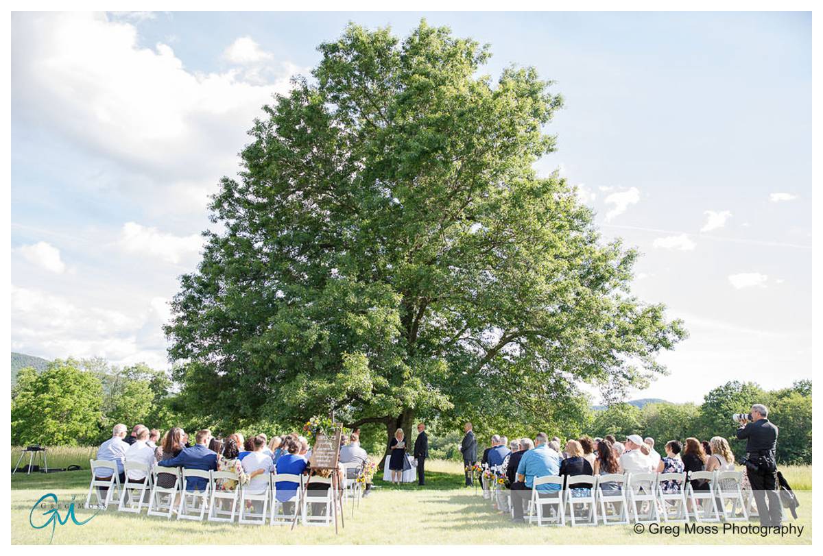 Wedding Ceremony by the tree at The Red Barn
