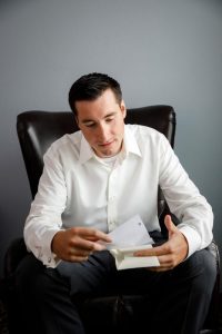 Groom reading letter from bride before wedding