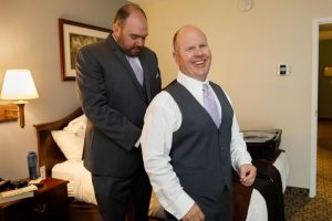 Groomsmen helping each other getting ready