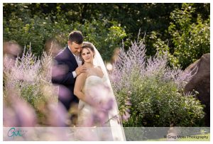Bride and groom portrait in front of flowers
