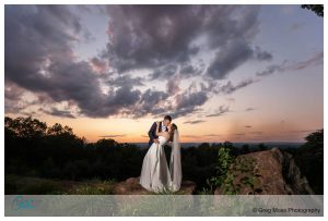 Stunning Dramatic sunset photo of wedding couple at the Log Cabin