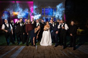 Bridal party and Bride and groom smoking cigars