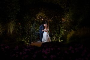 wedding couple under twinkle lights and ivy at Aria Wedding