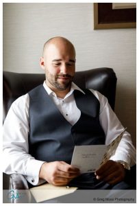 Groom reading letter from bride on the day of the wedding