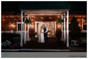 Bride and groom in front of the Log Cabin Holyoke at night