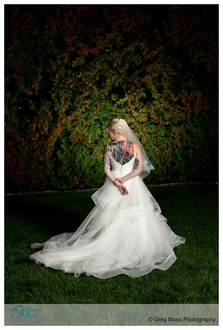 Portrait of back of bride in wedding dress in incredible ink