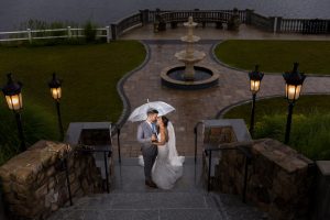 Night time Rain photo with wedding couple with clear umbrella on Stairs of the Grand view