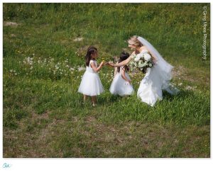 Bride with flower girls in field at top of Stratton Mountain Summit