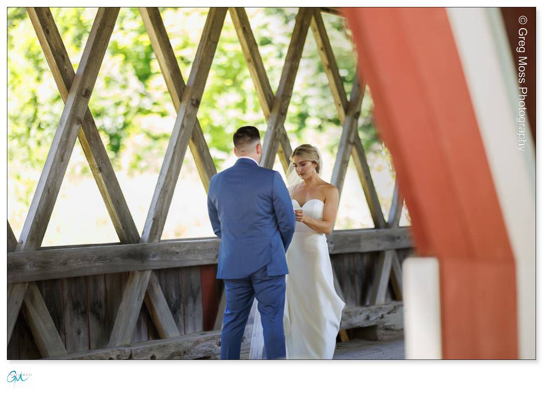 Bride and Groom first look inside covered bridge at Stratton Mountain