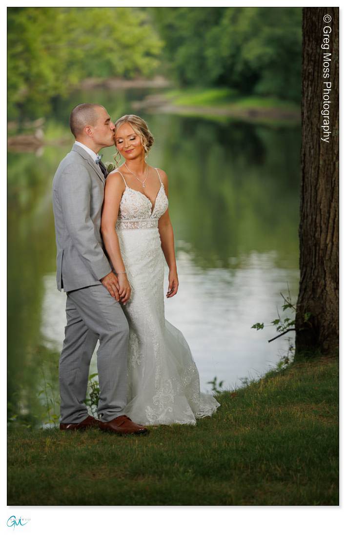 Bride and groom couple portrait in front of river