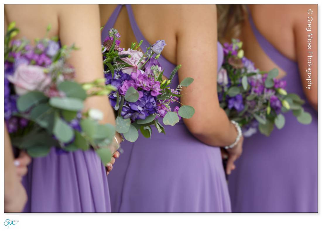 Bridesmaids with purple dresses and purple wedding flowers