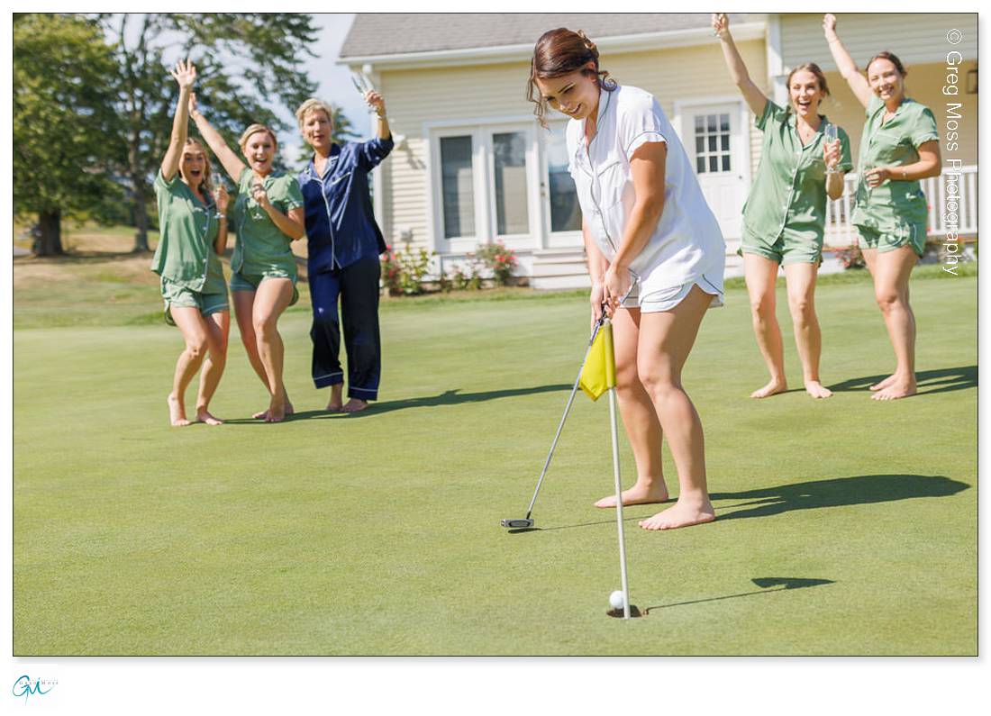 Bride making a putt with bridesmaid on putting green