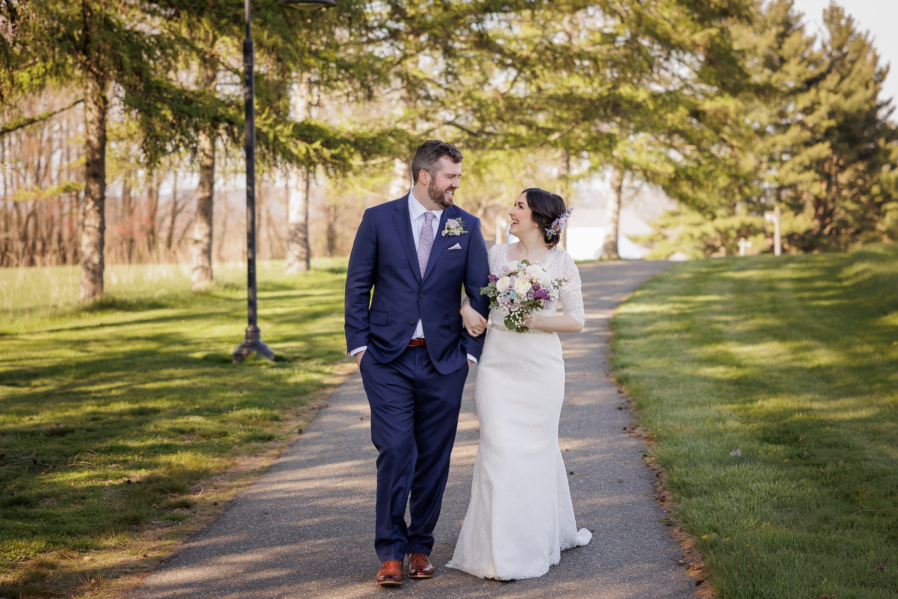 Bride and groom walking along path at Hampshire College